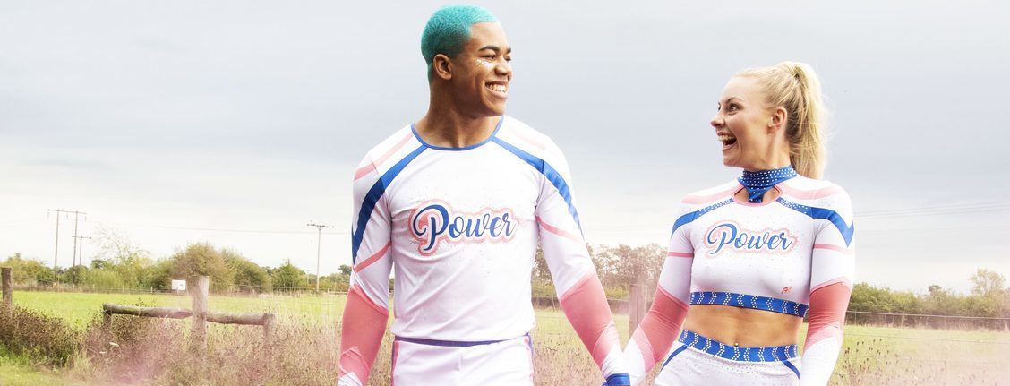 Man and woman holding hands in Power Nation cheer apparel